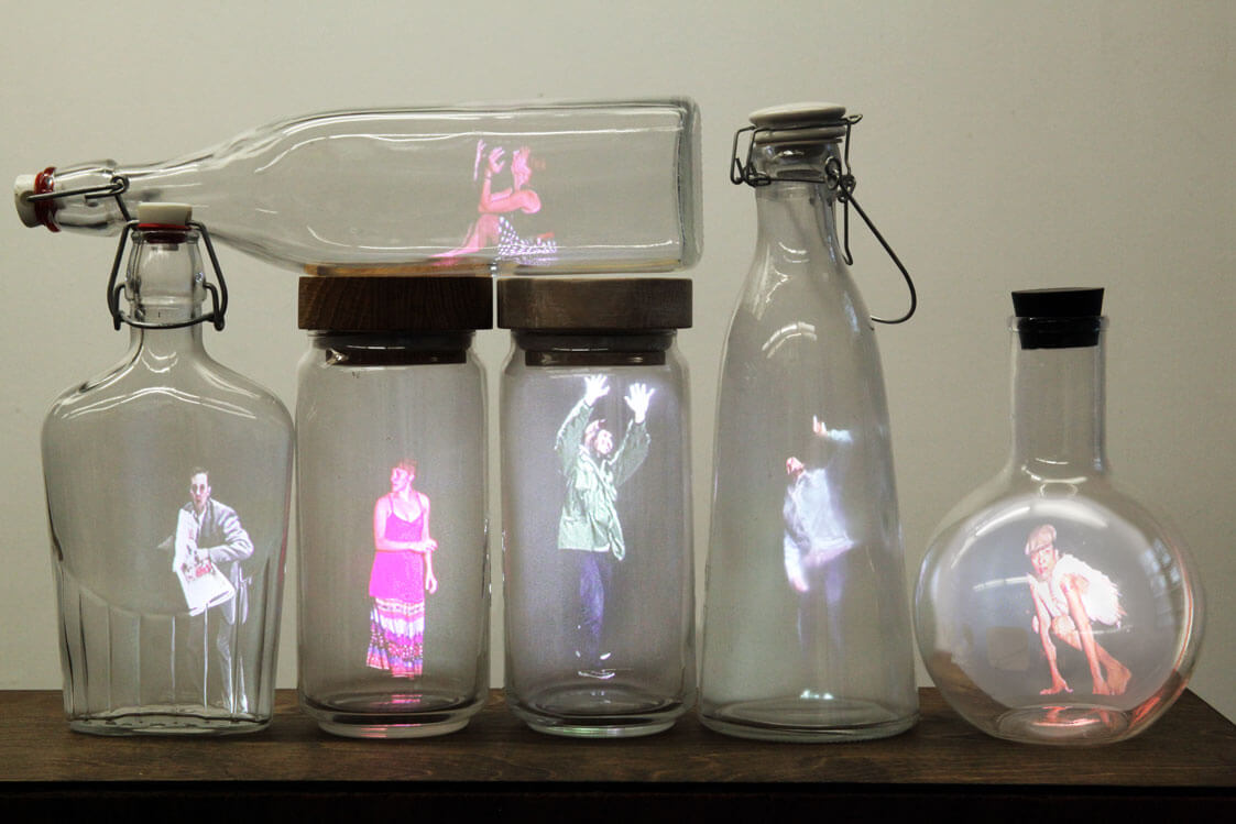 glass jars with hologram people inside