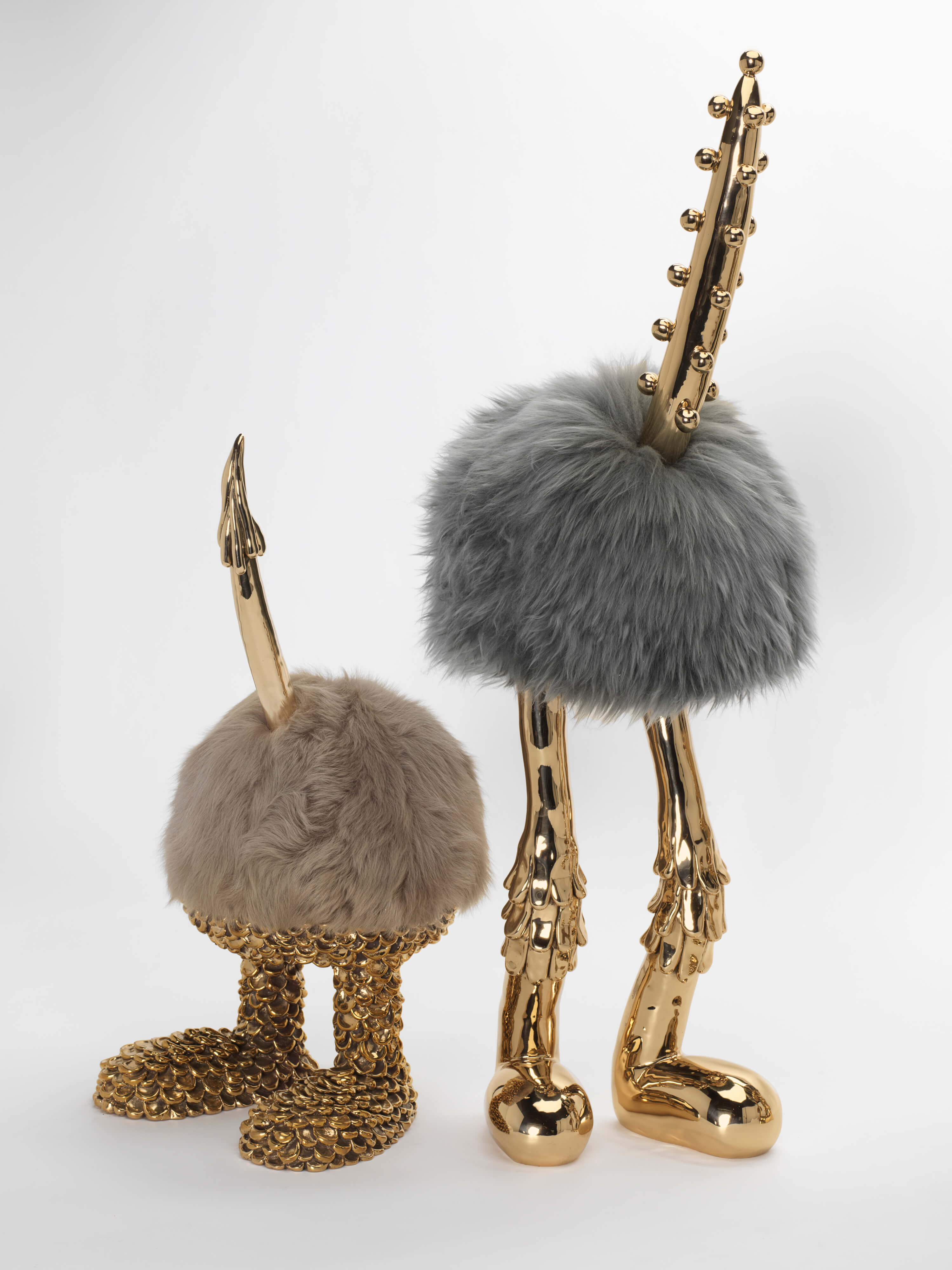 art installation of birds with fur body and bronze limbs