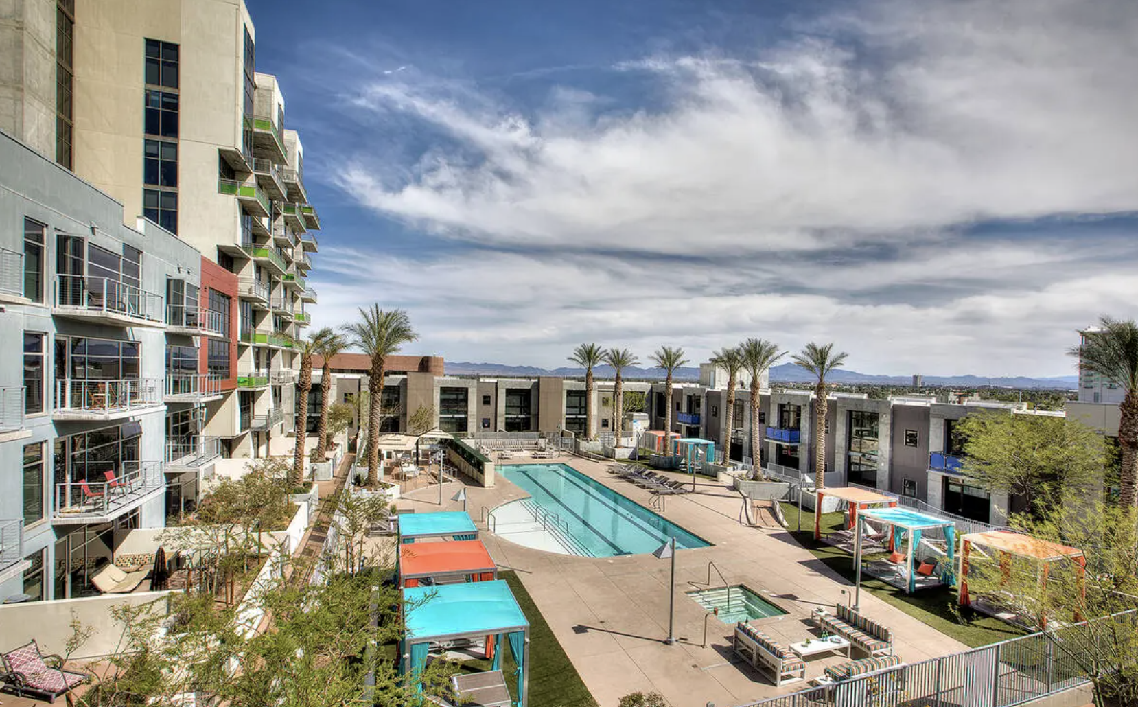 condo building sits around resort pool