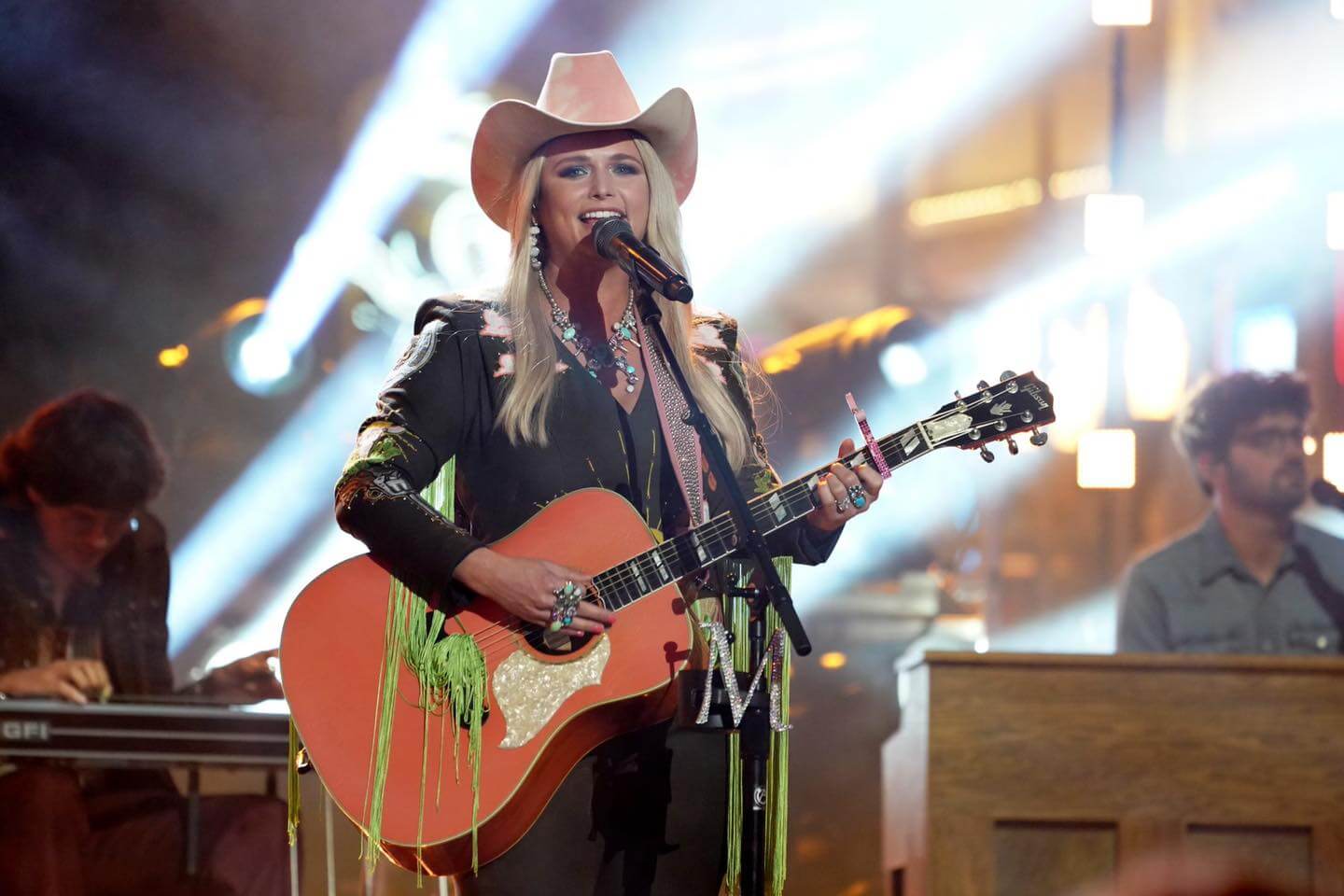 country singer performs with cowboy hat and guitar