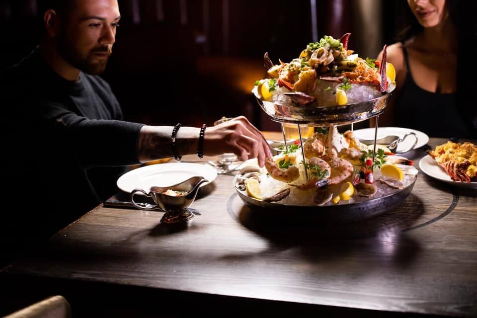 seafood tower is served to dinner table