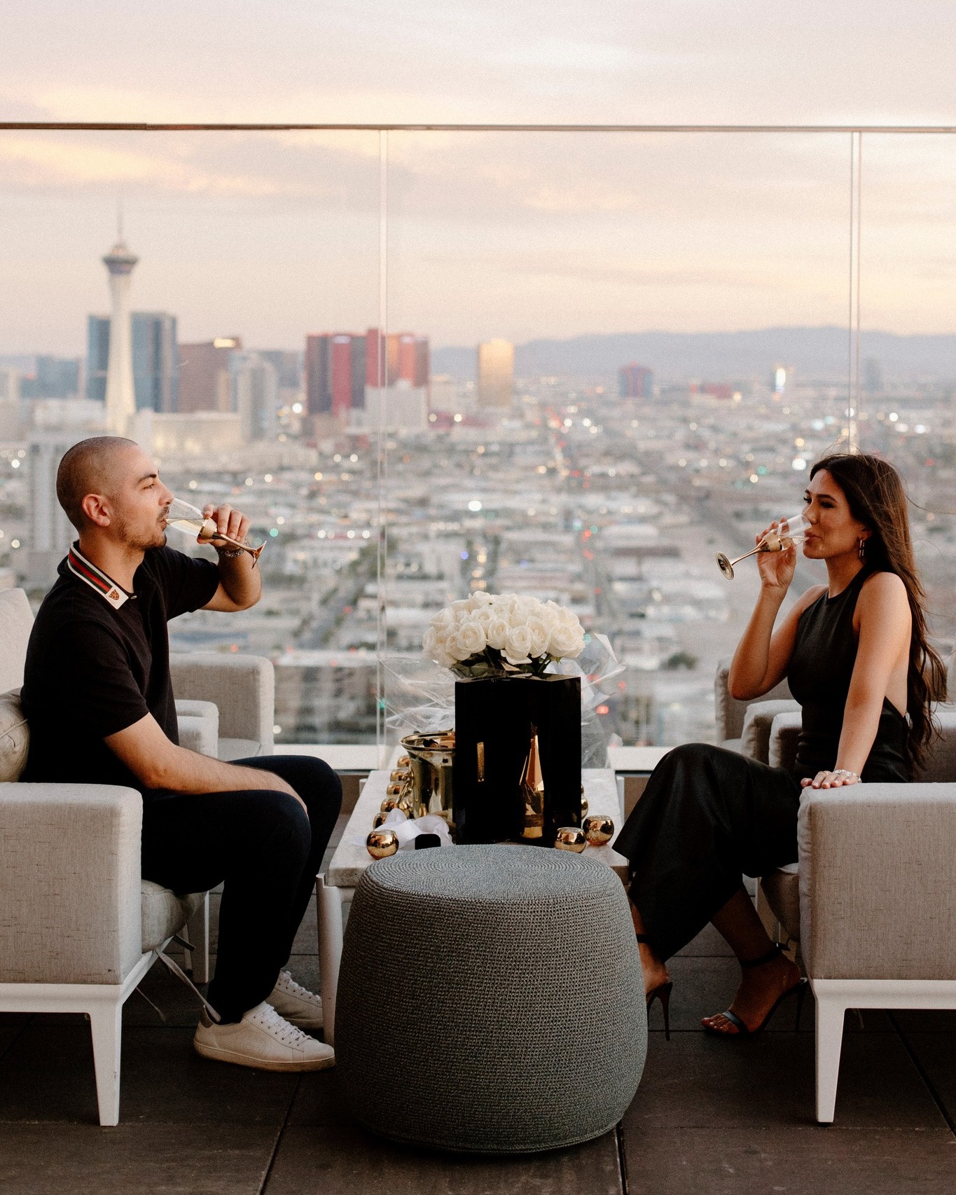 couple sips champagne with city views