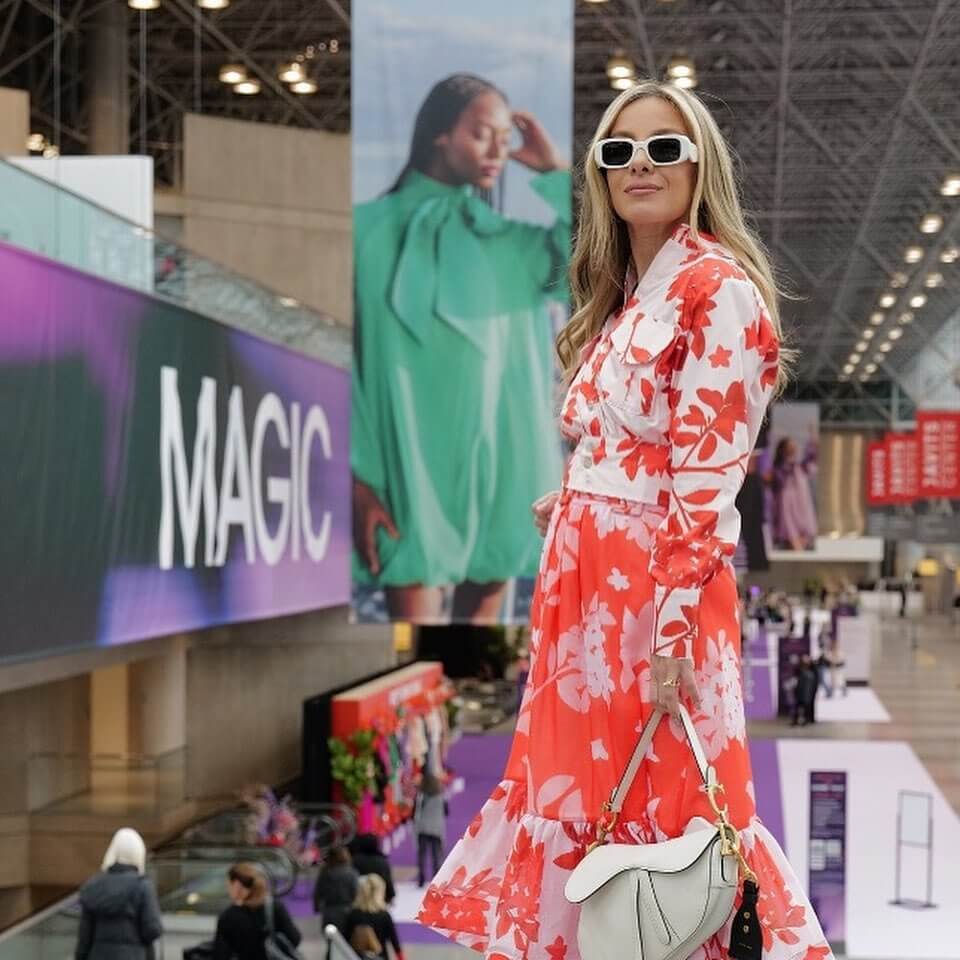 woman in long dress poses for camera at electronics covention