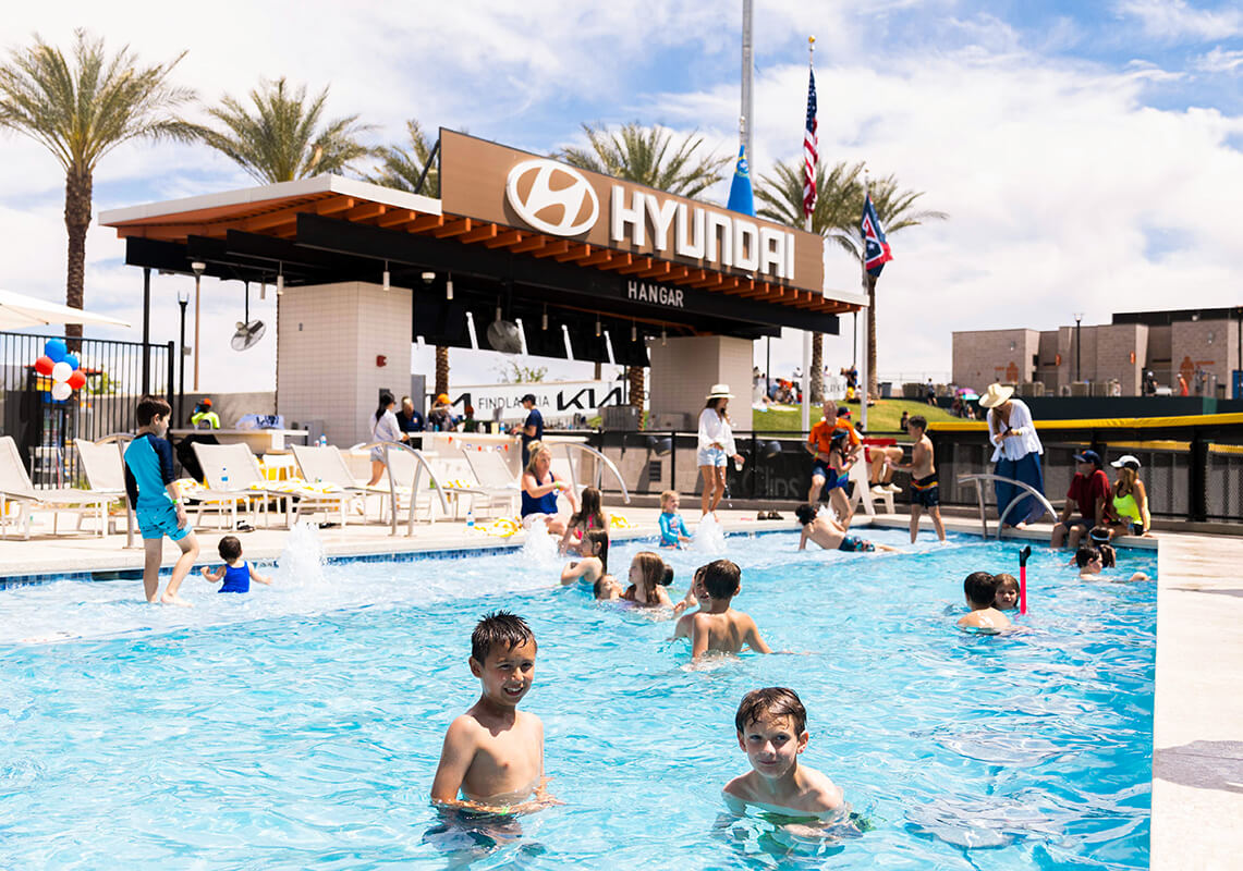kids swimming in resort pool on sunny day