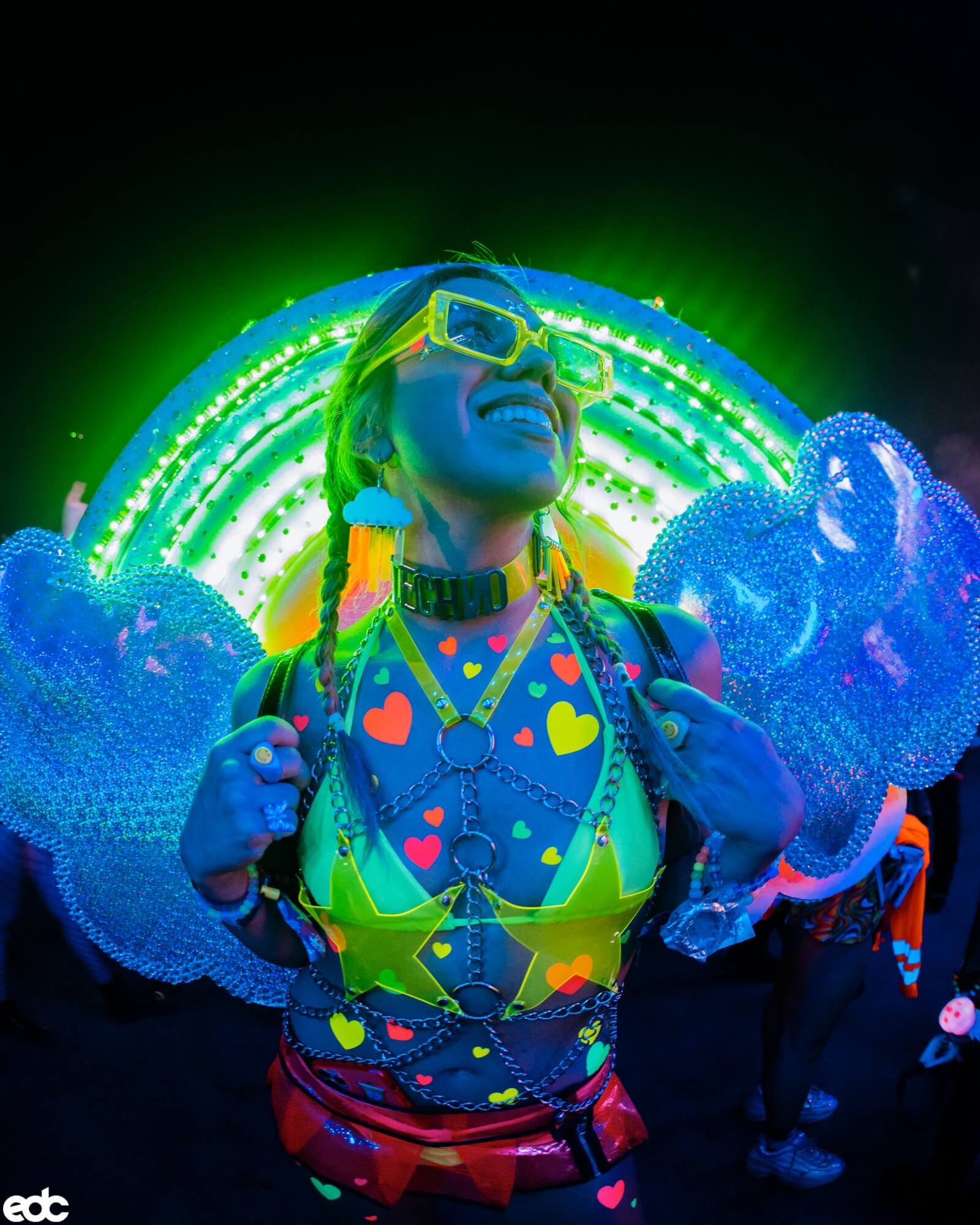 EDM fan dressed in electric neon outfit